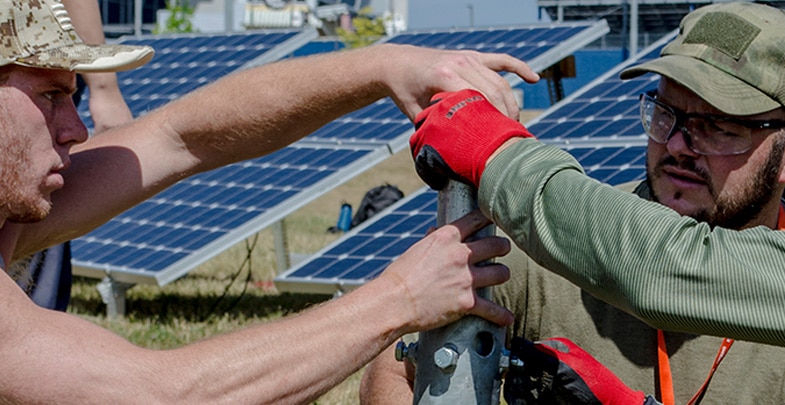 two men installing sustainable energy solar panels
